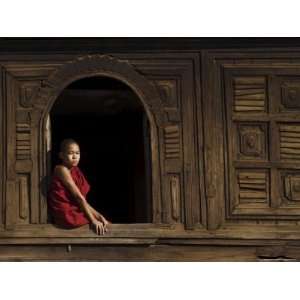 Novice Monk Sitting in Window of 18th Century Wooden Monastery of Nat 
