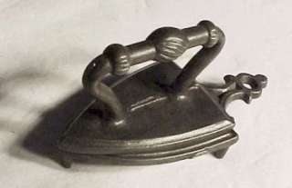 This 1800s cast iron toy sad iron measures 2 1/2 long X 1 1/2 wide 