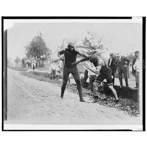   Jack Johnson fighting with opponent along a dirt road